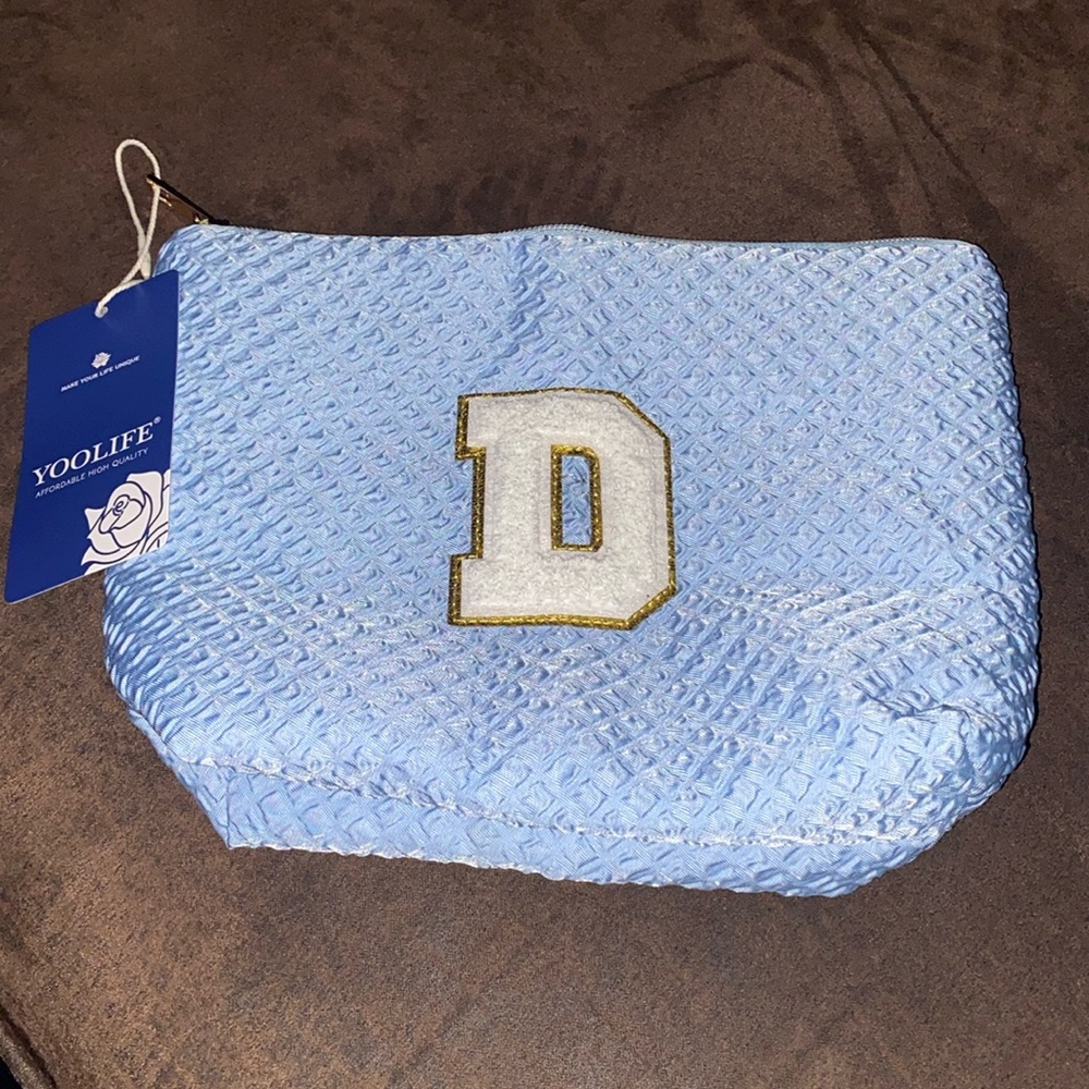 Monogram “D” travel make up bag